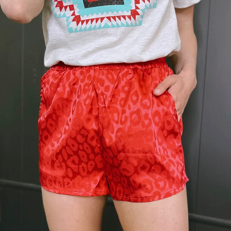 These Color Me Ruby Shorts are the purrfect way to hit the streets. Feel like royalty in this red cheetah print with a silk-like feel and spacious pockets--royalty never carries a purse anyway. Live out your wildest dreams and show 'em what you're made of!   97% POLYESTER 3% SPANDEX