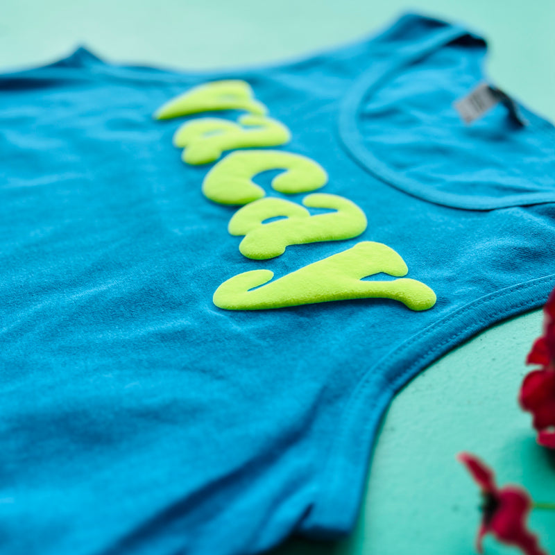 Take your style game up a notch with our Vacay Tank Top! Perfect for a summer day out, this turquoise tank is printed with the dreamy phrase, VACAY. Enjoy its raised 3D effect for a unique look, plus the premium cotton will keep you comfortable all day long. Ready for some fun under the sun? Get to VACAY-ING' in this tank!  100% Cotton