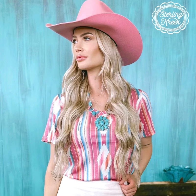 Stay cool and stylish in the Frio River Top! This unique top features a faded v-neck and a striking serape/aztec design that will have you standing out from the crowd. Perfect for any summer adventure, this fashionable piece packs a ton of style into a lightweight fabric, just add your favorite denim and you'll be ready to go!  94% modal, 6% spandex