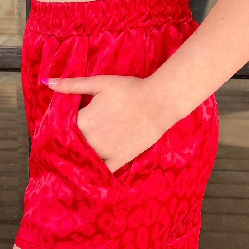 These Color Me Ruby Shorts are the purrfect way to hit the streets. Feel like royalty in this red cheetah print with a silk-like feel and spacious pockets--royalty never carries a purse anyway. Live out your wildest dreams and show 'em what you're made of!   97% POLYESTER 3% SPANDEX