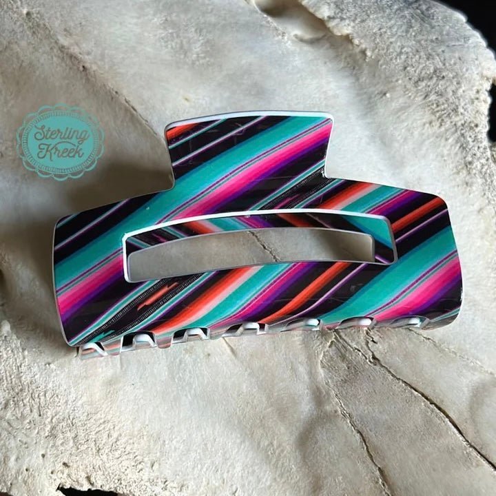 Lookin' sassy? Tame that mane with this funky serape print hair clip! With its unique southwestern style, you'll be turnin' heads wherever you go. Equally perfect for a night on the town or a day at the beach, this hair clip will have you lookin' saucy and fabulous!  L 4 X W 1.5 X H 2