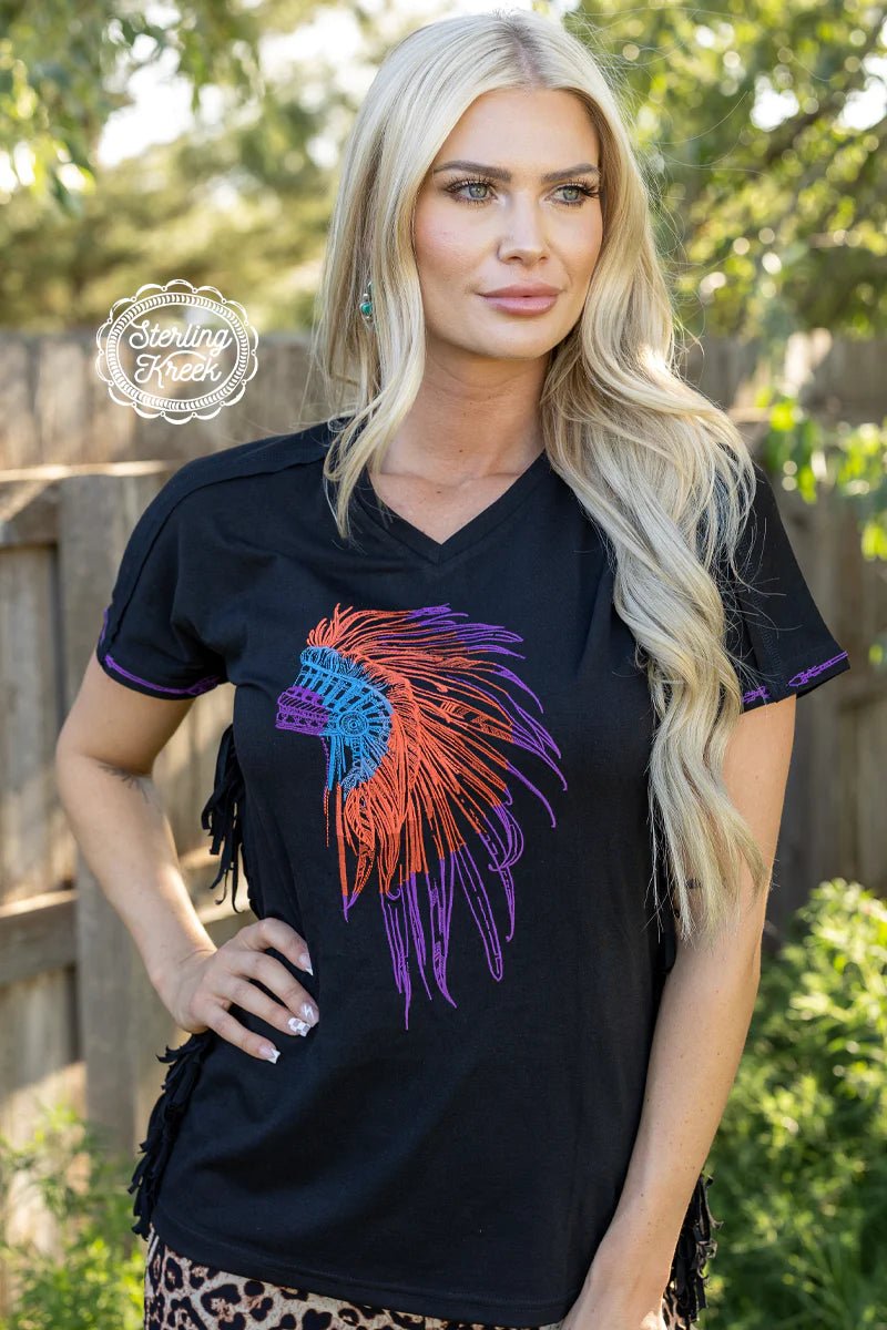 You don't need tribal relics to make a statement - just put on the CHEROKEE NATION TOP! This black top comes with an eye-catching black fringe on the sides and a stylish embroidered indian head dress with pops of purple, orange and turquoise. Feel proud and stay fashionable - you'll be head of the tribe in no time!  60% polyester 35% rayon 5% spandex