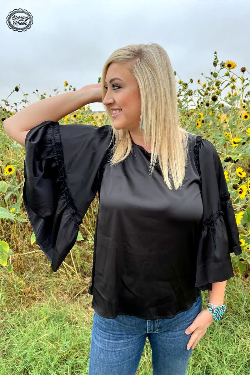 Looking for a way to shake up your evening wardrobe? Introduce the Into the Night Top into the mix! This sleek black shirt is made from silky material and features some majorly flowy sleeves for maximum twirl-ability. Get ready for all eyes to be on you when you take to the dance floor!  100% POLYESTER