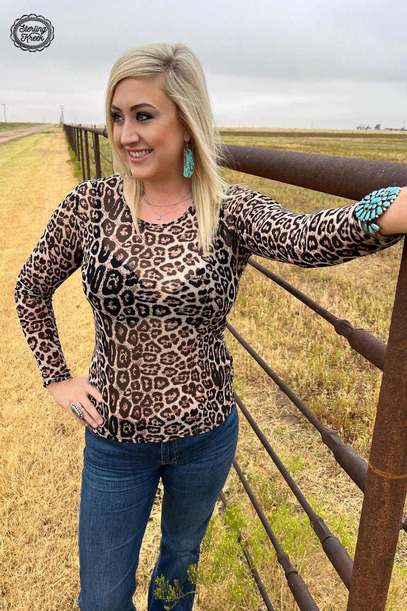 The Kitty Queen Top is your ultimate edgy look! This leopard mesh top features a swoop neckline for a fierce yet flirty look that is perfect for any occasion. Show off your style and unleash your inner wildcat! 🐱  96% POLYESTER 4% SPANDEX