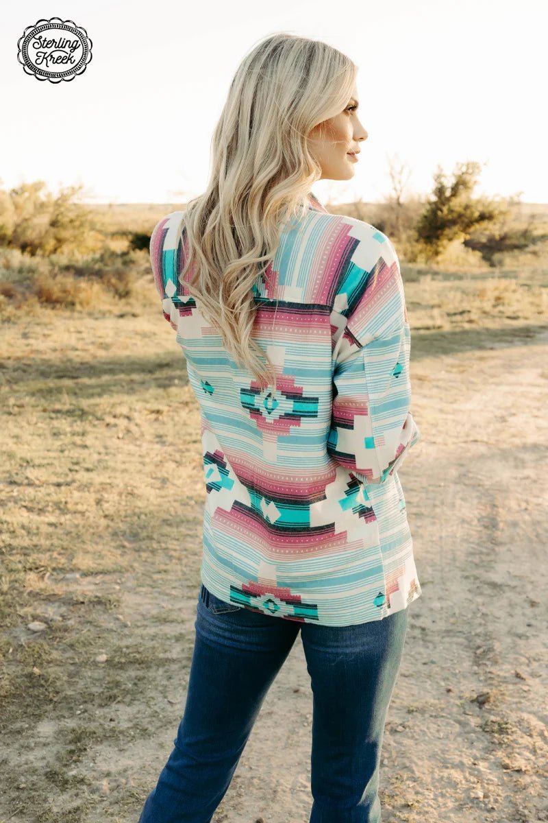 Meet Me In The Middle Shacket! This shacket is the perfect blend of style and comfort, featuring a pink, turquoise, and cream aztec print and cute button details. Snazzy enough to dress up any look!  68% polyester 28% rayon 4% spandex