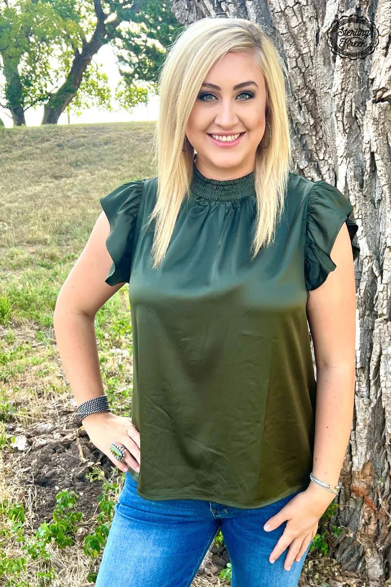 This babydoll top is not just any hunter green, it's HUNTER green! So stand out and be ready to "bag" all the compliments! Slip into this silky-smooth short sleeve top and be the life of the party! *Pairs well with our Champagne City fringe Jacket.  100% polyester 