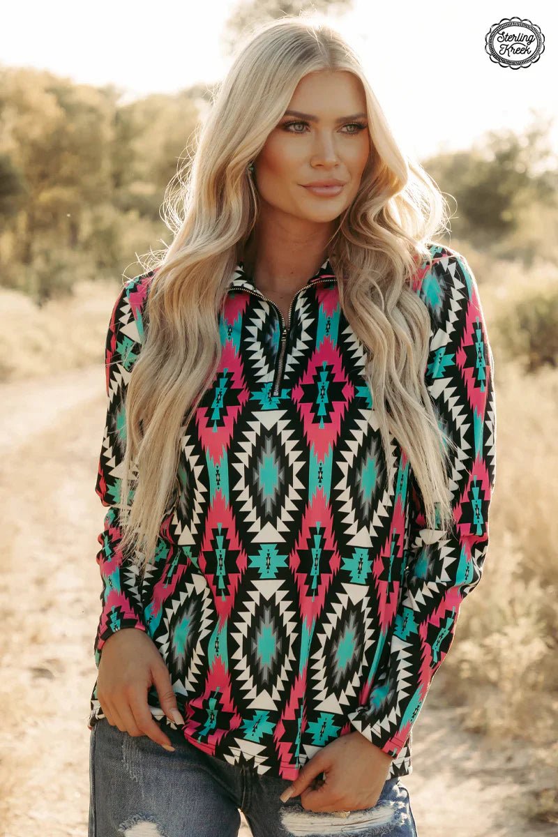 Look cool and stay warm in the Montezuma Pullover! This fashionable yet cozy quarter-zip sweater features a unique aztec pattern in soothing shades of pink, white, black and turquoise. Plus, you get two convenient pockets to stash your stuff in! A real steal--the perfect addition to your winter wardrobe.  32% Cotton, 56% Rayon, 12% Spandex  Related Fit   