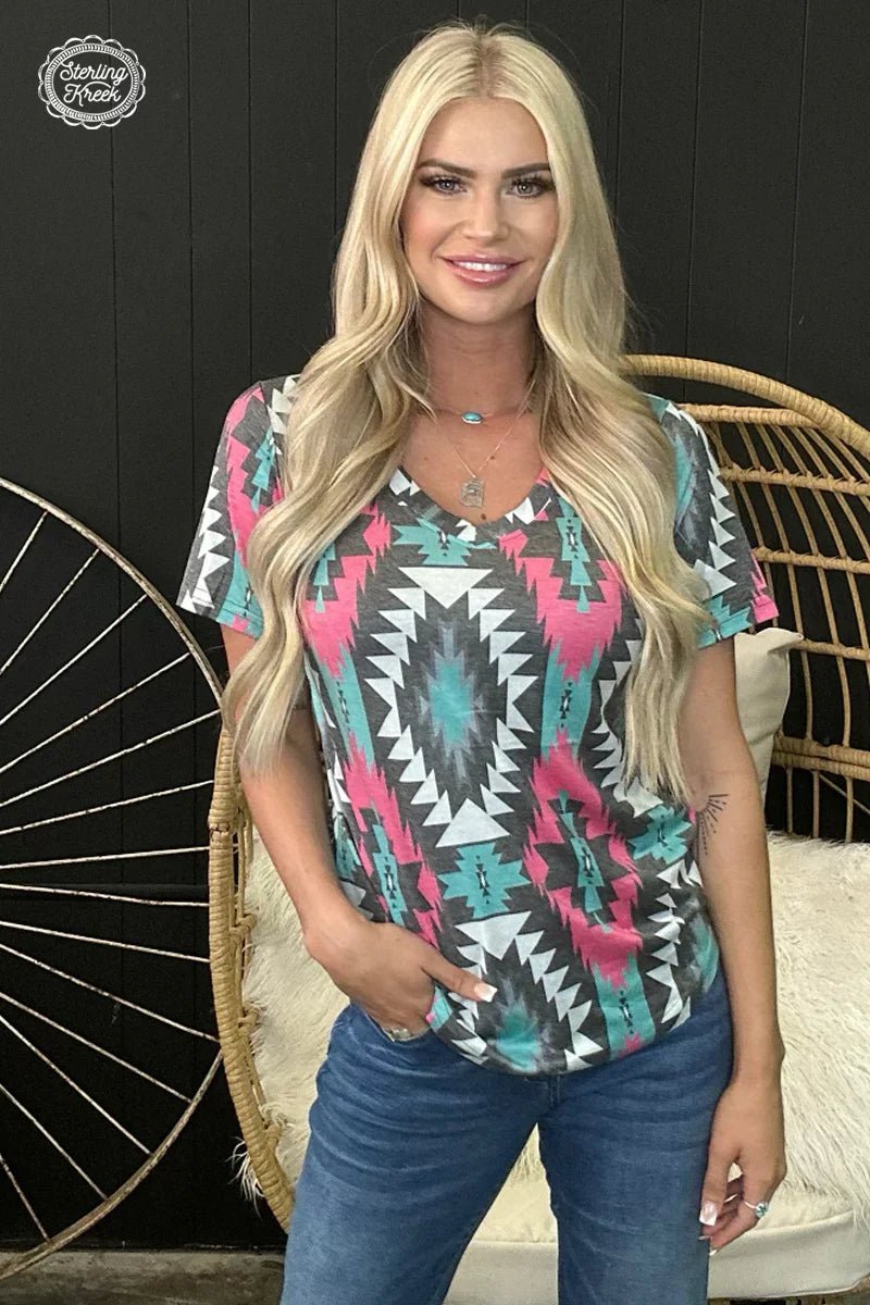 Make a statement with this fierce Montezuma Top! Boasting a sleek pink, turquoise, gray and white aztec pattern, it's sure to turn heads! Stay looking as cool as the other side of the pillow with this one-of-a-kind v-neck that rocks a faded look. Yeah, that's how you style!