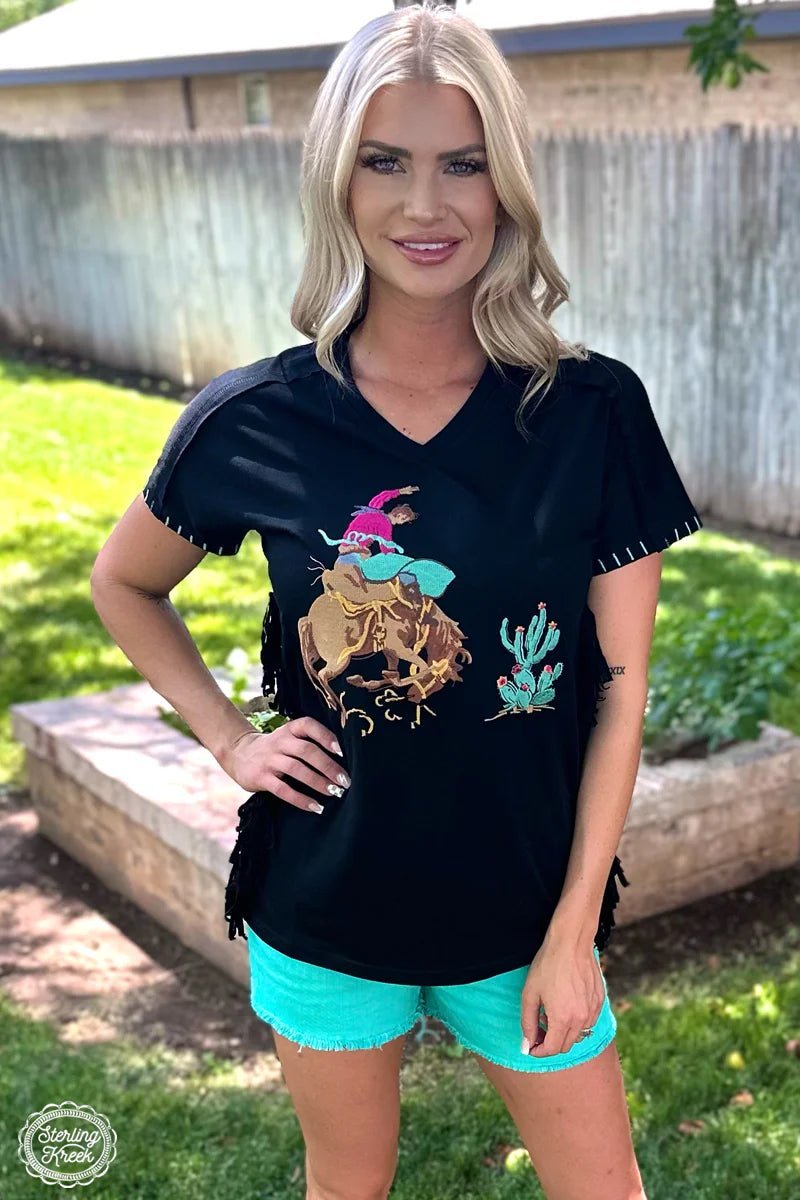 You don't need tribal relics to make a statement - just put on the CHEROKEE NATION TOP! This black top comes with an eye-catching black fringe on the sides and a stylish embroidered indian head dress with pops of purple, orange and turquoise. Feel proud and stay fashionable - you'll be head of the tribe in no time!