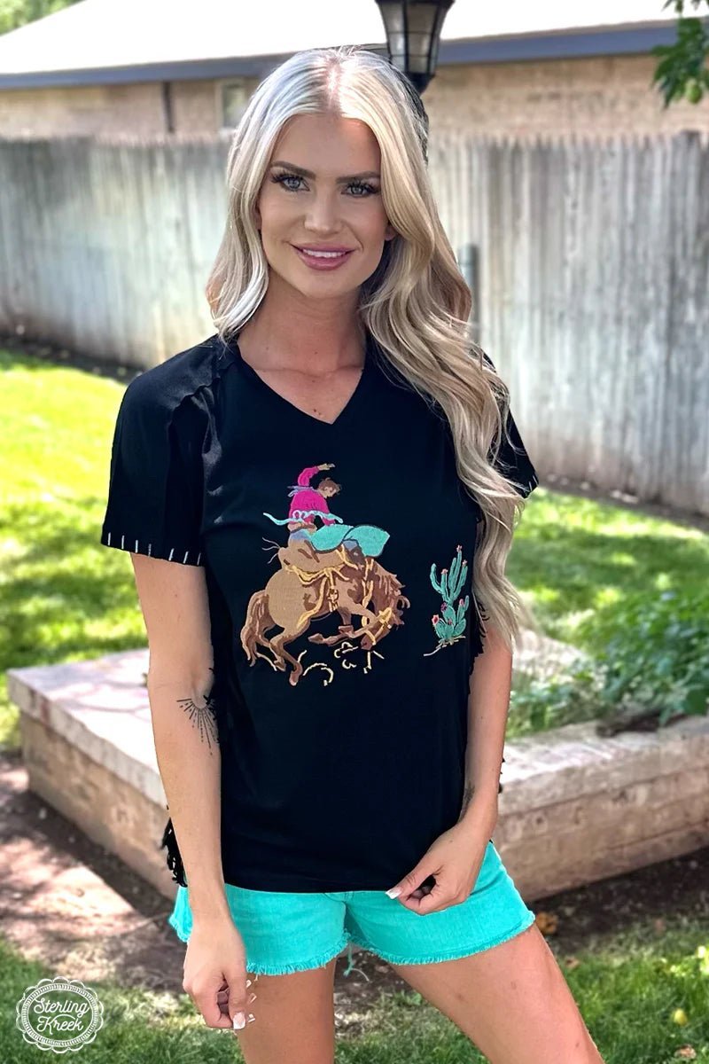 You don't need tribal relics to make a statement - just put on the CHEROKEE NATION TOP! This black top comes with an eye-catching black fringe on the sides and a stylish embroidered indian head dress with pops of purple, orange and turquoise. Feel proud and stay fashionable - you'll be head of the tribe in no time!