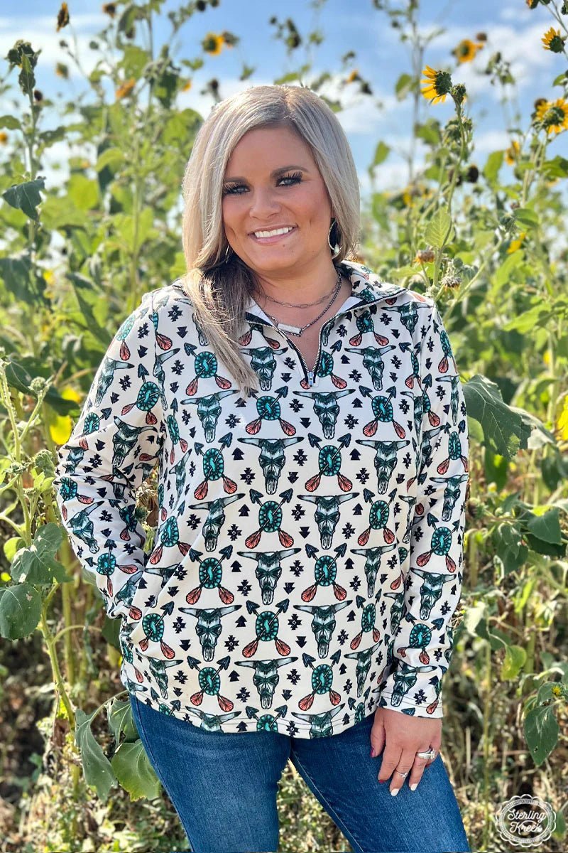 This pullover is sure to rock your wardrobe with a wild western vibe! It's cream-colored with an awesome tribal pattern, complete with cow skulls, turquoise conchos, and arrows. Yee-haw! It is the relaxed fit and has pockets!  84% POLYESTER 16% SPANDEX