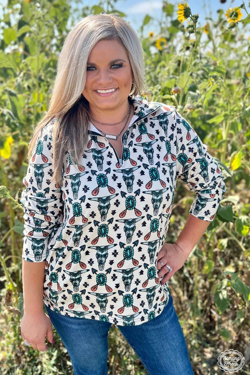 This pullover is sure to rock your wardrobe with a wild western vibe! It's cream-colored with an awesome tribal pattern, complete with cow skulls, turquoise conchos, and arrows. Yee-haw! It is the relaxed fit and has pockets!  84% POLYESTER 16% SPANDEX