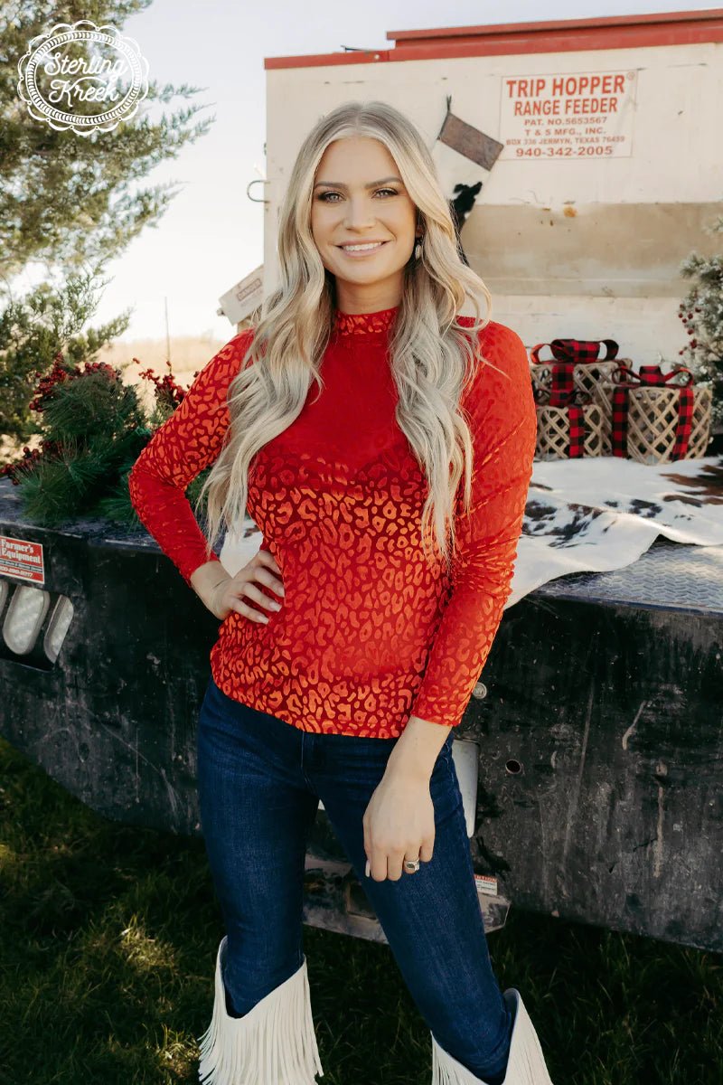 Turn heads in the RUBY RED PANTHER TOP! This long sleeve red mesh top is sure to make a statement with its red velvet cheetah design – paws-itively wild! Now get ready to party like a real big cat... rrrroarrrr!  96% POLYESTER 4% SPANDEX