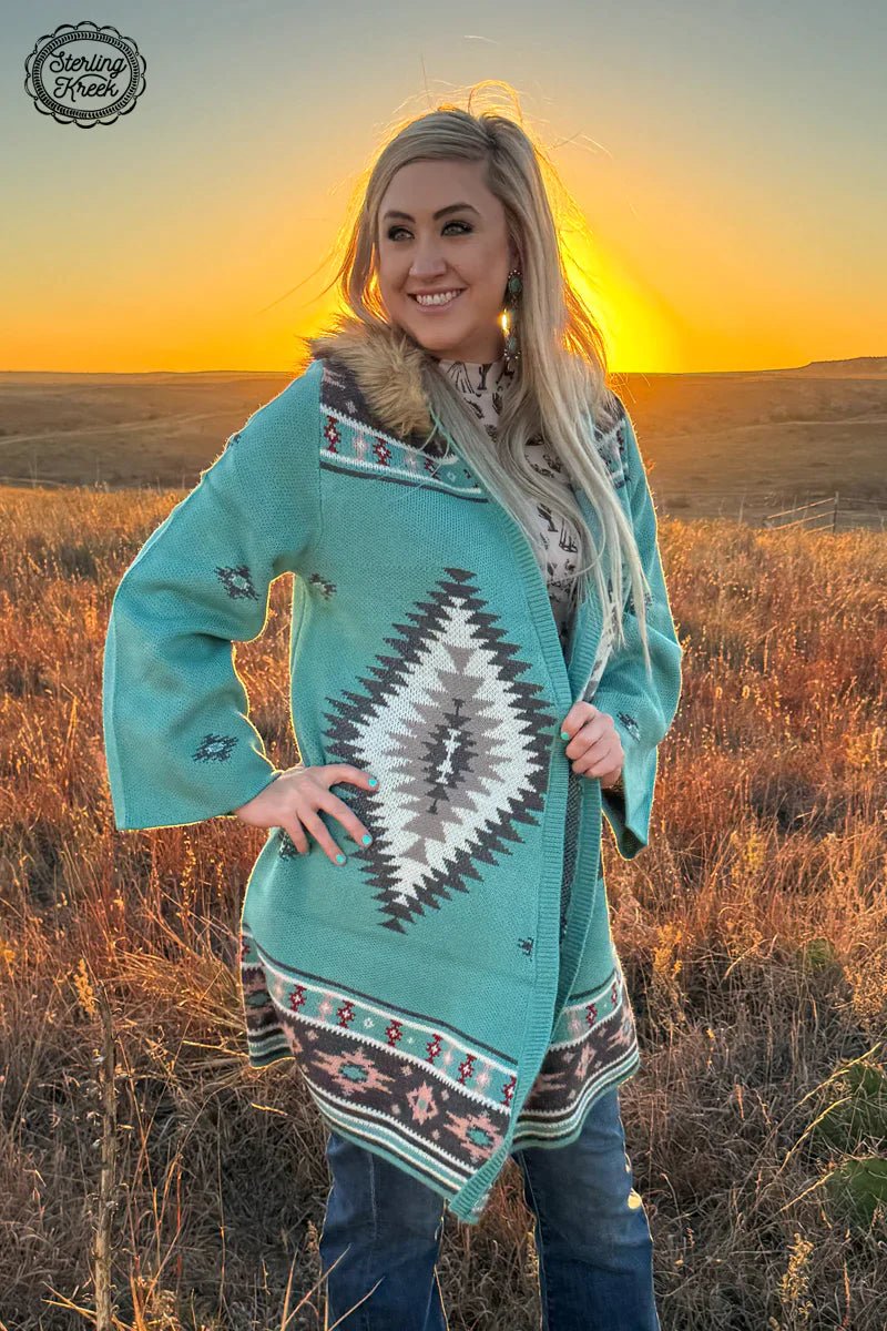Bring out your inner wild child with this playful turquoise knit cardigan! Featuring an Aztec design, this chic cardigan will spice up any look. With an added bonus of a cozy hood and faux fur strap, this cardigan will make any outfit stand out!  100% ACRYLIC