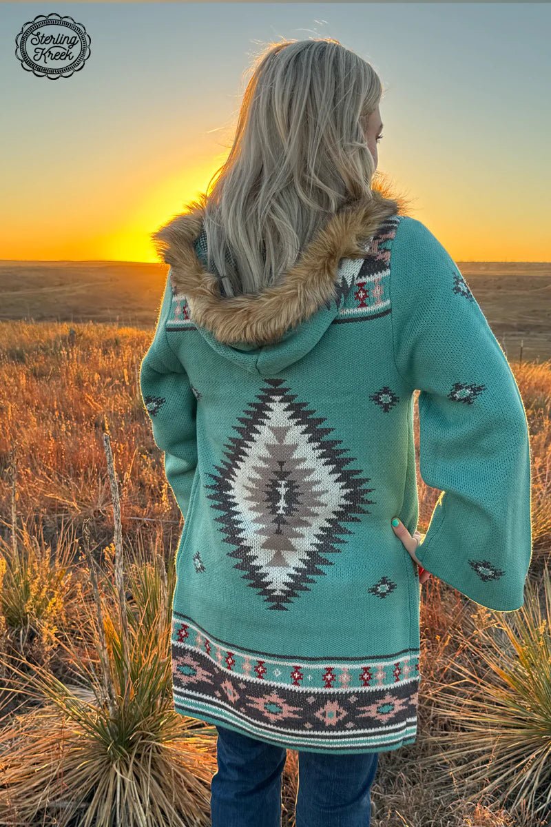Bring out your inner wild child with this playful turquoise knit cardigan! Featuring an Aztec design, this chic cardigan will spice up any look. With an added bonus of a cozy hood and faux fur strap, this cardigan will make any outfit stand out!  100% ACRYLIC