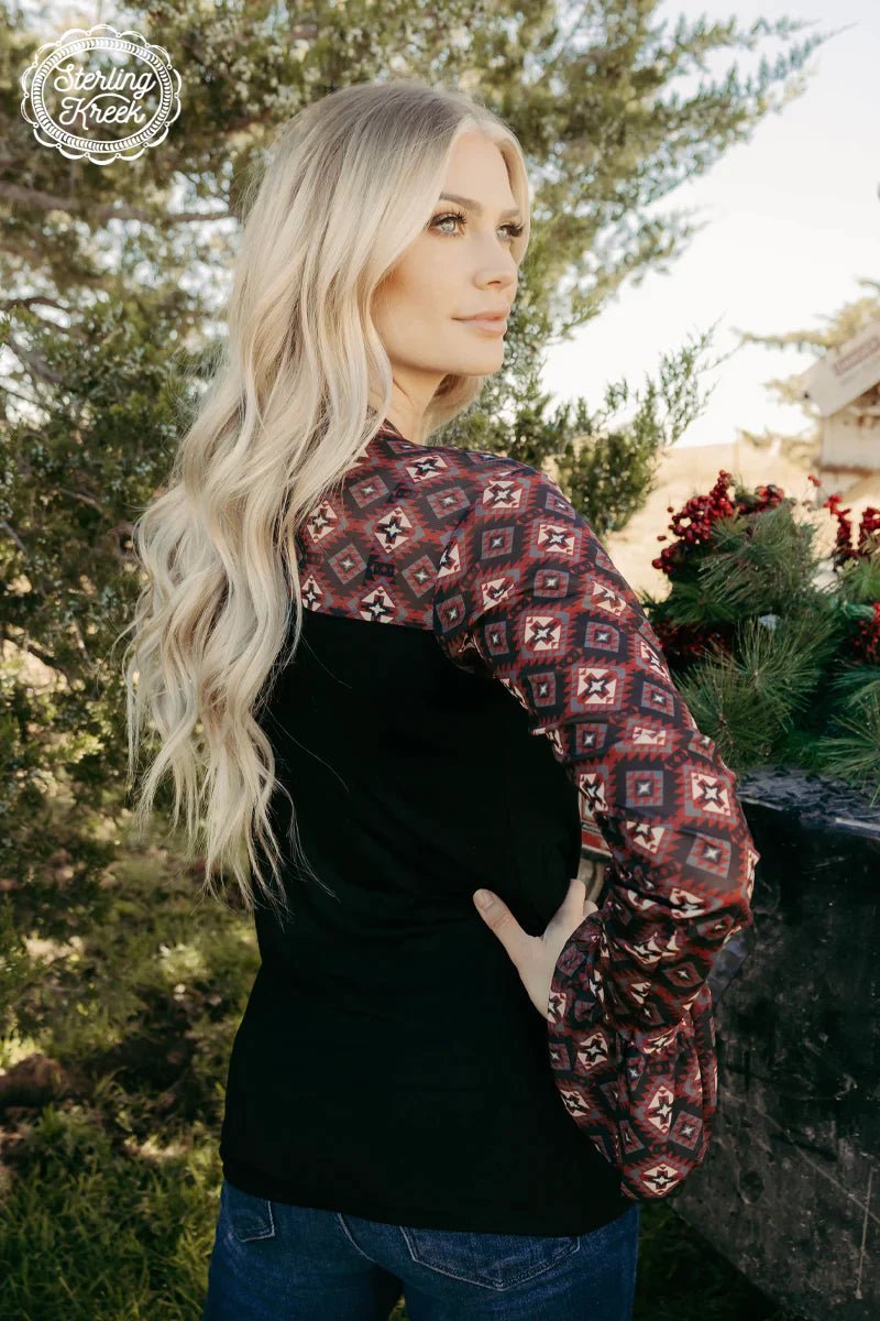 Looking to stay warm but rock a unique style? Our SEE IT THROUGH TOP has got you covered! This black top has a mesh top and sleeves featuring a stunning black maroon and cream aztec design, plus ruffled sleeves to add some extra oomph. It's the perfect mix of comfort and fashion!  94% MODAL 6% SPANDEX