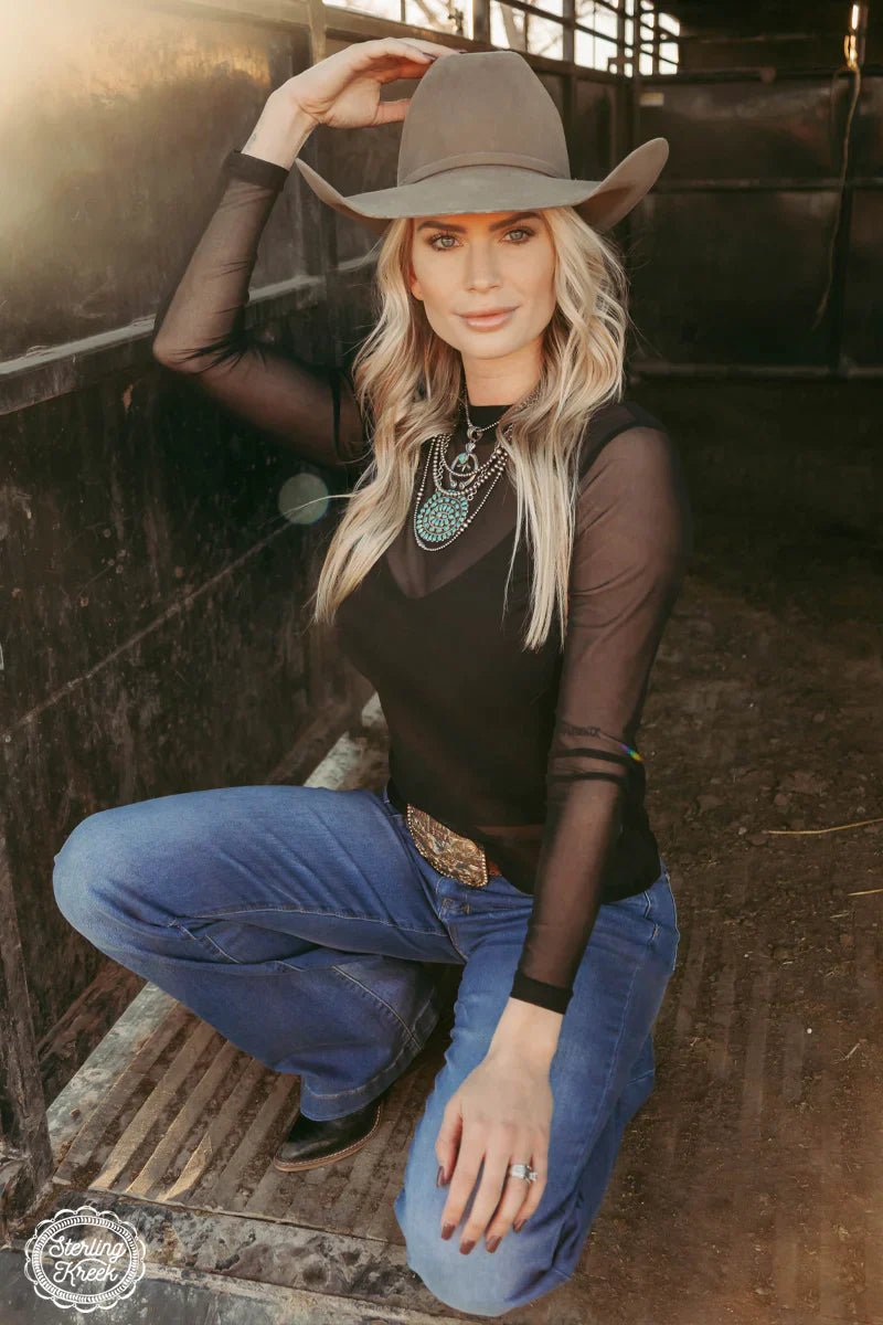 Get ready to rock the night with our Night Sky Top! This solid black long sleeve mesh top is the perfect combination of edgy and classic. Show off your unique style and stay comfortable in this must-have top. Perfect for a night out or a casual day look.  96% POLYESTER 4% SPANDEX