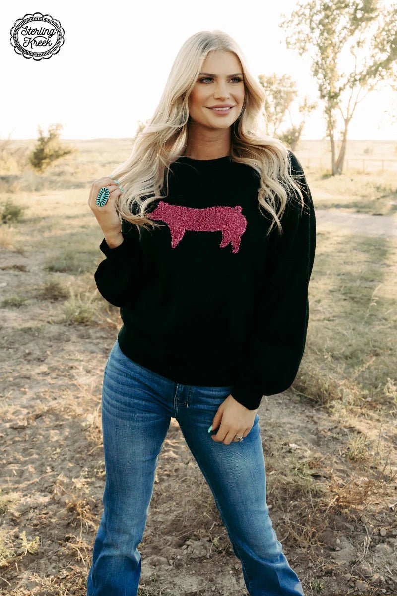 This Queen of Stockshow Sweater is the perfect way to add quirk to your wardrobe! Featuring a black sweater with bubble sleeve and a pink piping pig, it's sure to make your next show day outfit très chic. Be crowned Queen of the show ring!  99% ACRYLIC 1% POLYESTER