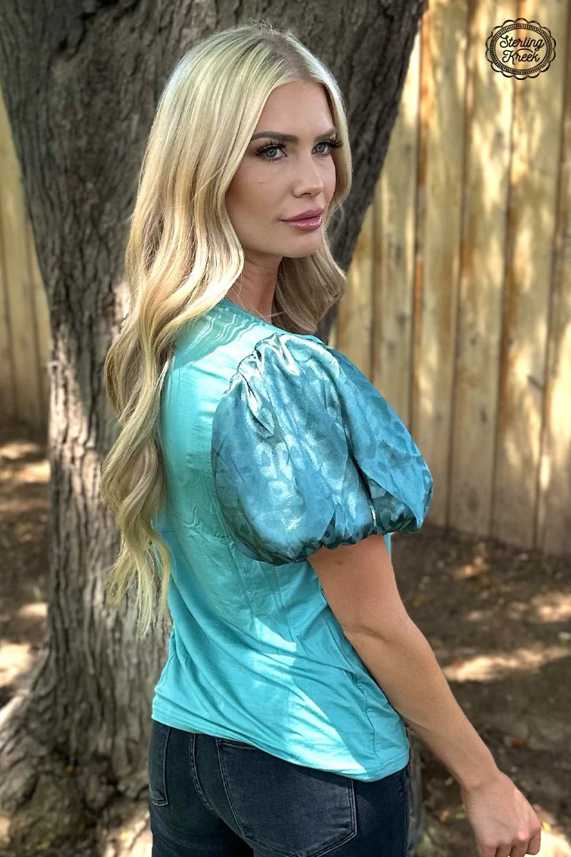 Look wild in the teal cheetah Louisiana Woman Top! This fashion-forward top features luxurious bubble sleeves, ensuring that you make a statement wherever you go. Rock this unique style and let the world know you mean business!