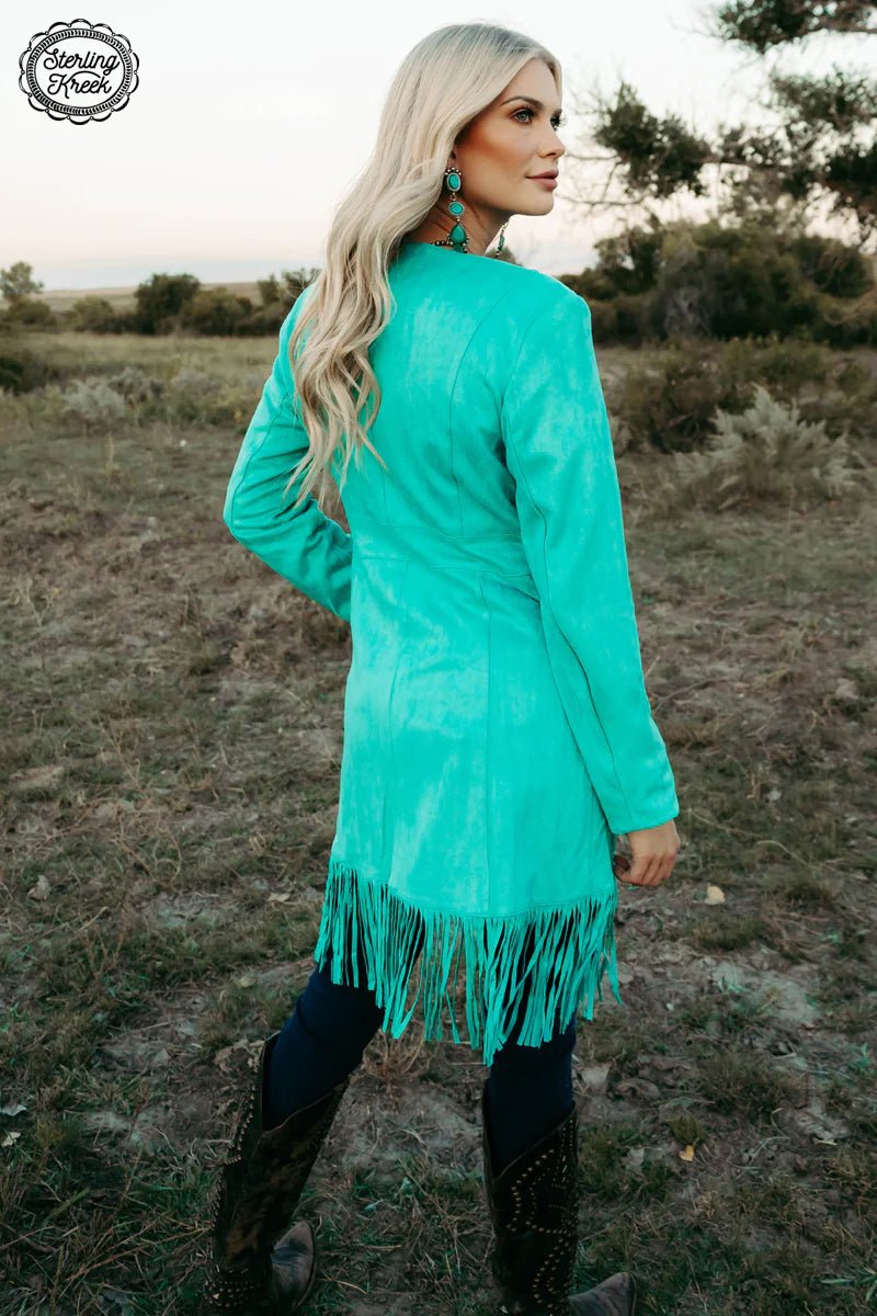 Look wild and stylish with this Scottsdale Suede Jacket! With a bold turquoise color, standout fringe, and a concho lining to sweeten the deal, you'll be the envy of any room you enter! Not to mention, the suede material guarantees a soft, comfortable fit all night long. Get ready to rock this statement jacket, nothin' else will do!  SHELL : 92% POLYESTER LINING: 100% POLYESETER