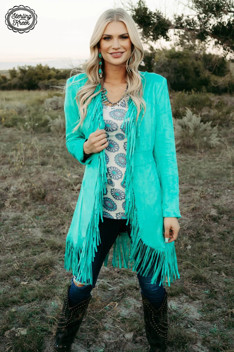 Look wild and stylish with this Scottsdale Suede Jacket! With a bold turquoise color, standout fringe, and a concho lining to sweeten the deal, you'll be the envy of any room you enter! Not to mention, the suede material guarantees a soft, comfortable fit all night long. Get ready to rock this statement jacket, nothin' else will do!  SHELL : 92% POLYESTER LINING: 100% POLYESETER