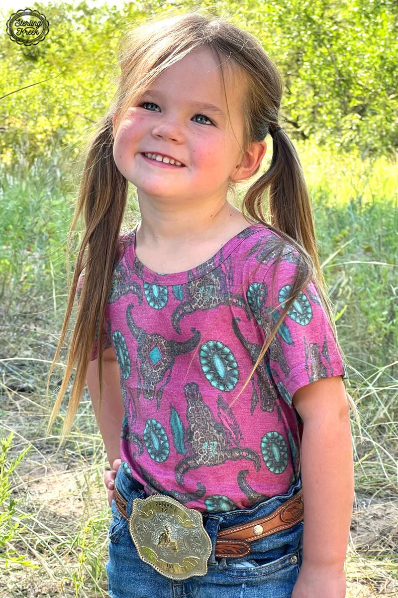 Got a wild side that needs showing? Our Mini Wild Thing Top does the trick with its fierce pink hue, cheetah cow skulls, and turquoise conchos. Talk about purr-fectly sassy!     26% Cotton, 69% Polyester, 5% Spandex