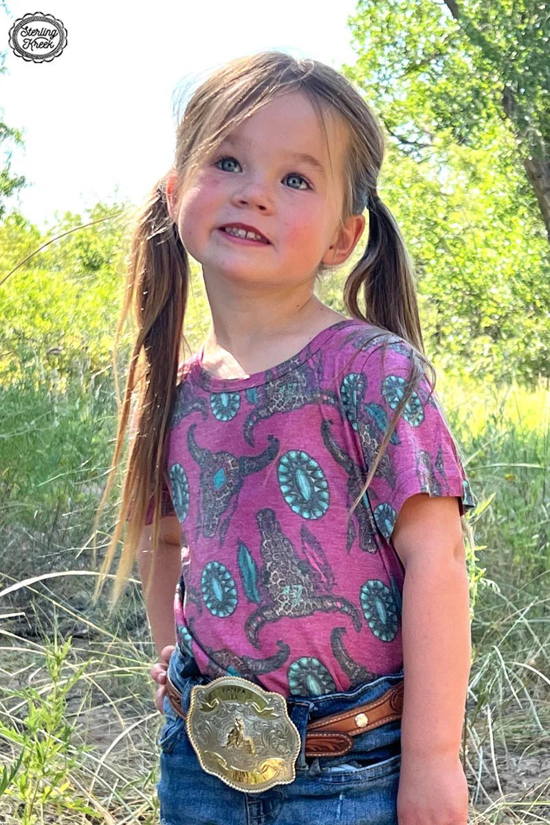 Got a wild side that needs showing? Our Mini Wild Thing Top does the trick with its fierce pink hue, cheetah cow skulls, and turquoise conchos. Talk about purr-fectly sassy!     26% Cotton, 69% Polyester, 5% Spandex