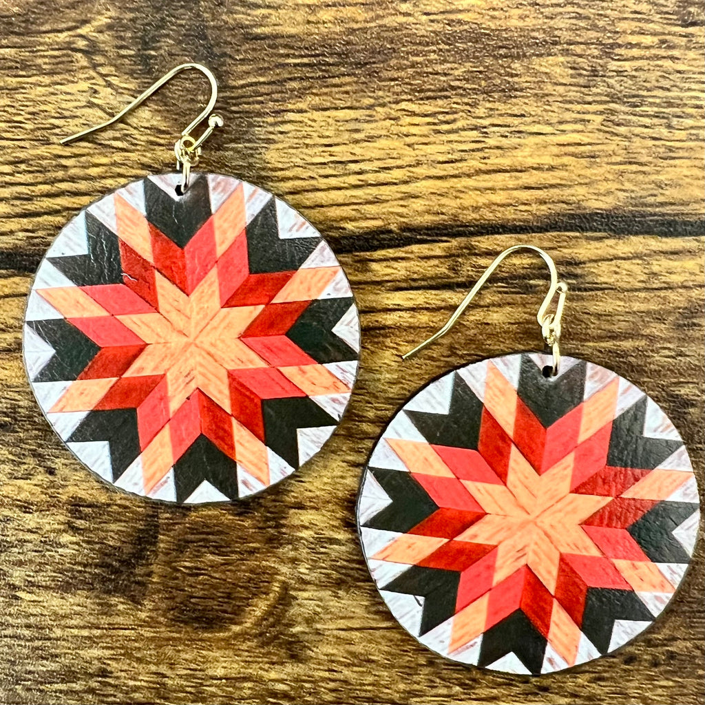 The Zia Aztec Earrings are a 2" Leather Round Cut with Aztec Print. These earrings are a mix of Oranges, Black, and Off White in Color. They have that old rustic wooden look. These earrings are very lightweight and Beautiful!!