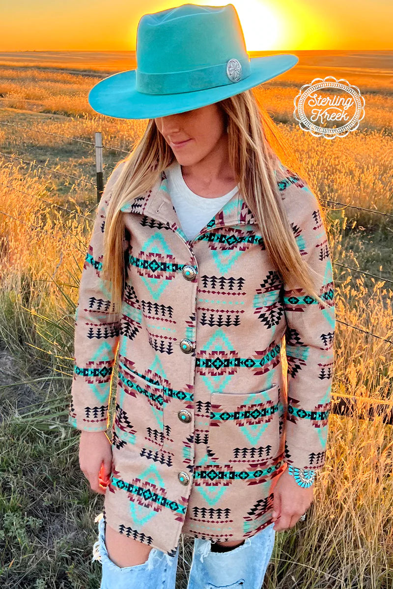 The Colorado Sunset Jacket is a Gorgeous Mocha Colored longer Jacket with a multi colored Aztec Print Pattern and Beautiful Turquoise Concho Buttons. This Jacket is 32" in total length from the shoulder to bottom. It has double open pockets on the front. The colors paired in this jacket are Gorgeous!!!  93% Polyester, 7% Spandex  XS,S,M,L,XL