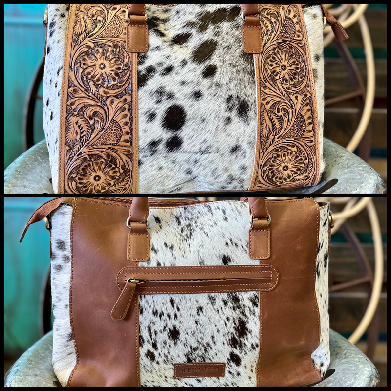 Mary Alice's Bag is an exquisite, handcrafted accessory featuring Hair On Hide material with a unique tooled floral pattern. It comes with two convenient straps - a 14" double hand strap and a 44" adjustable/removeable shoulder strap - available in three different hide options to suit any style.  Dimensions: 16"W X 10"H