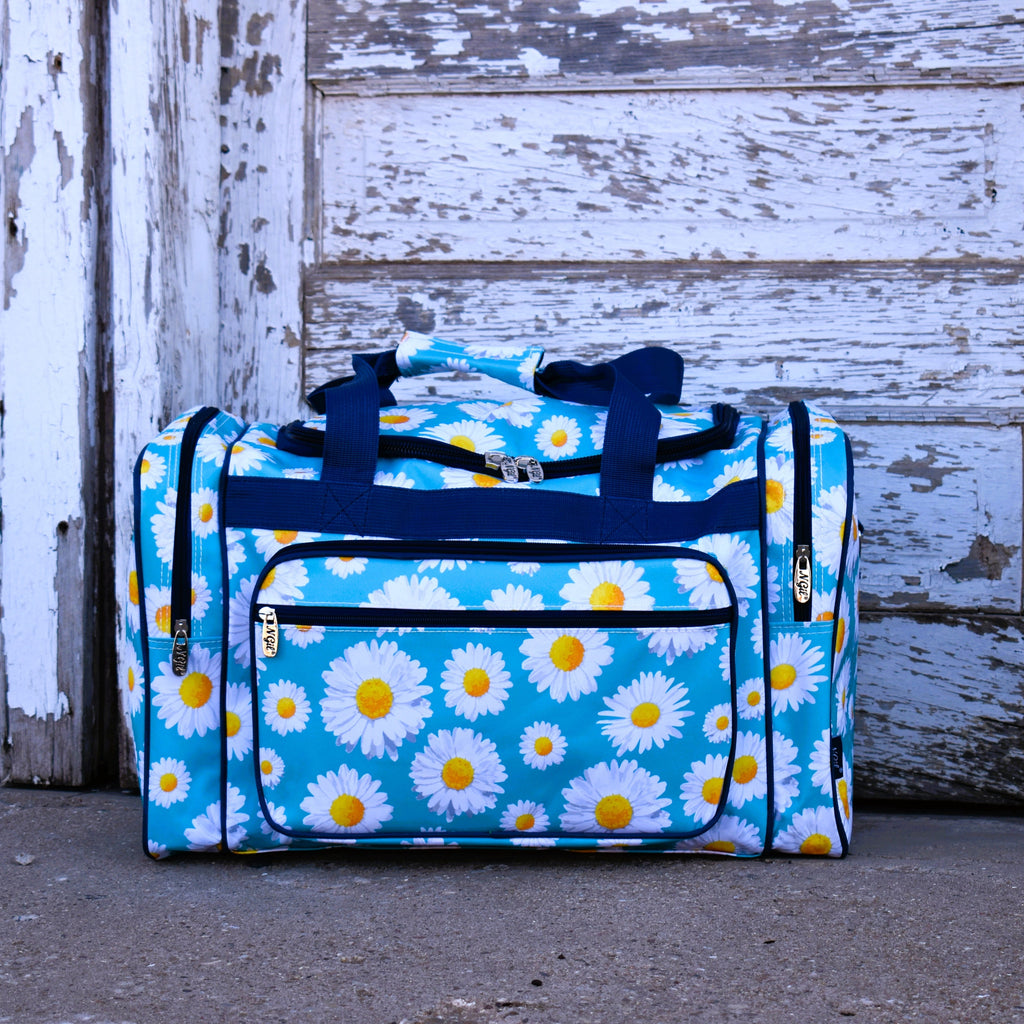 sky blue vinyl duffle bag with allover white daisy print and navy straps