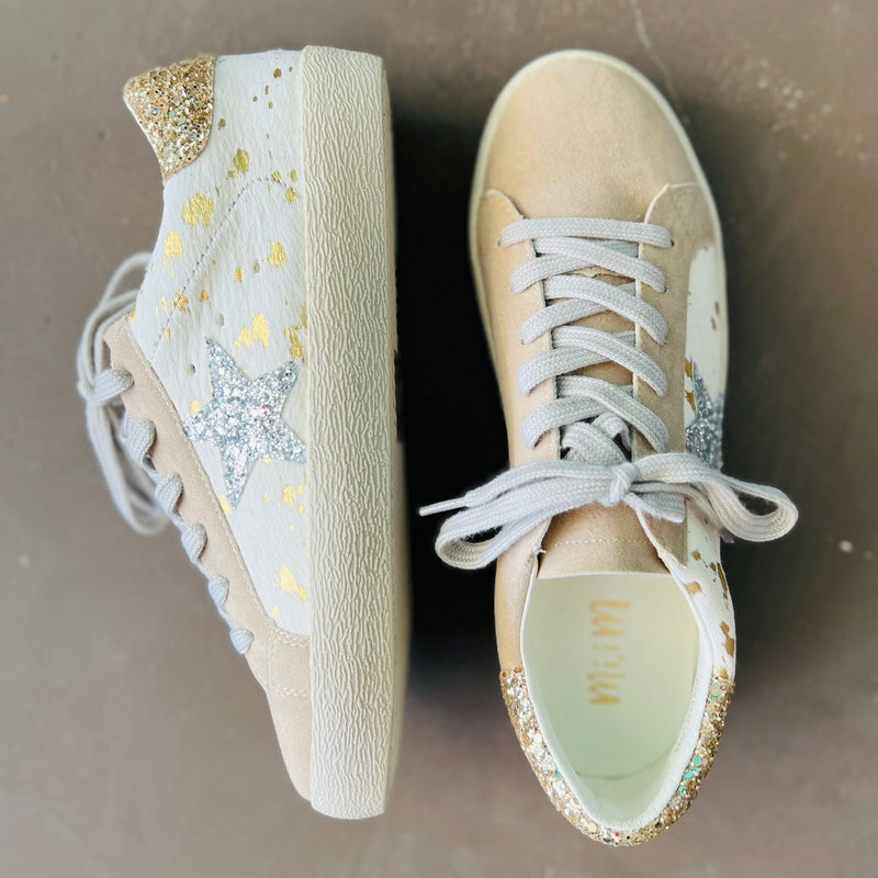 The Golden Cow Sneakers are adorable white and gold cow print with a silver glitter star on the side and tan toe. The sneaker has gold glitter back and grey shoe laces. The material of these sneakers will be easy to clean.