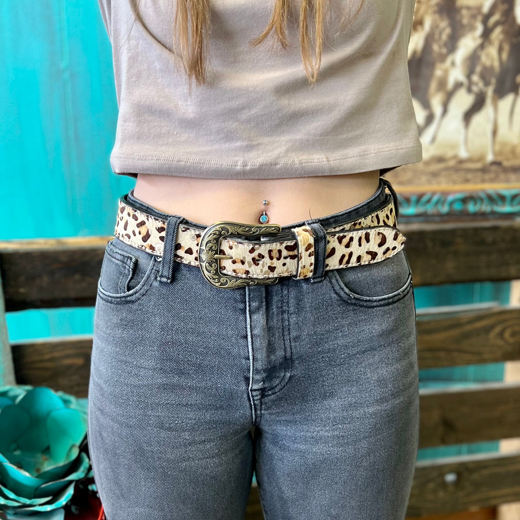 This belt is faux hair on hide leopard print with gold splatter accents. This belt will add character to any outfit.   1.5" WIDE