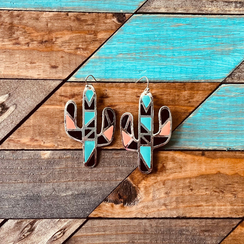 The Mosaic Desert Earrings are an Aztec Print and colorful print silver earrings with fish hook backs. They are a Cactus cutout. They are  2" L X 1 1/4" W  in length. The colors in these earrings make these earrings pop!!
