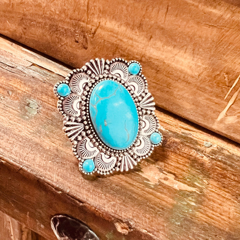 My Turquoise Terrain Ring  is a Western Concho Style cuff ring. The ring is 2" in Diameter.   It is super light weight and can be adjusted to fit any size finger. Super Cute!! The beautiful Concho Style with the large turquoise stone in the center and the 4 small stones on each corner. 