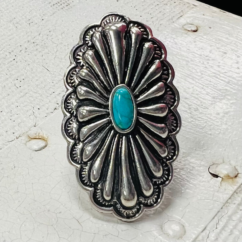 The Oval Platter Ring is a Western Concho Style cuff ring. The ring is 1" W X 2" L.  It is super light weight and can be adjusted to fit any size finger. Super Cute!! The beautiful Concho Style with the small turquoise stone is amazing. 