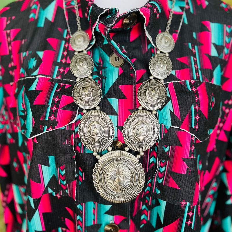 The Concho Statement Necklace is a 32" silver necklace with stair step size conchos on each side and a 3" Concho Pendant.  Classy and Beautiful like you!  *matching earrings included*