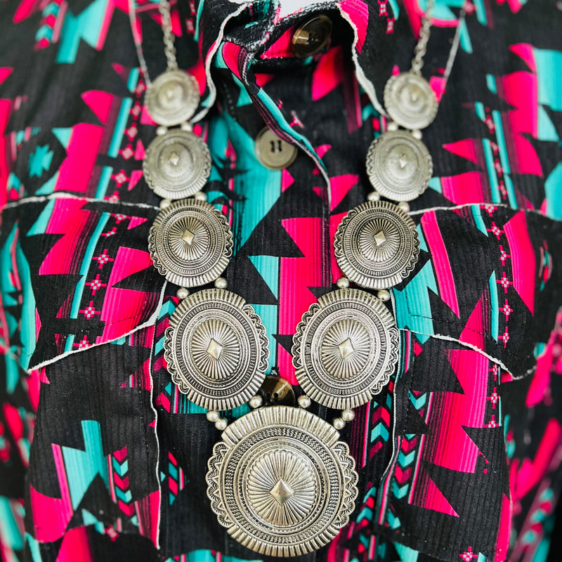 The Concho Statement Necklace is a 32" silver necklace with stair step size conchos on each side and a 3" Concho Pendant.  Classy and Beautiful like you!  *matching earrings included*