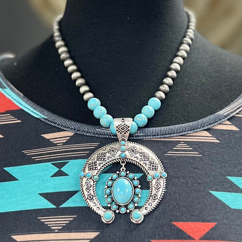 Turquoise stone squash blossom set on a 20" Navajo Pearl and Turquoise Stone Necklace with a 3" adjustable clasp.   *Matching earrings included*