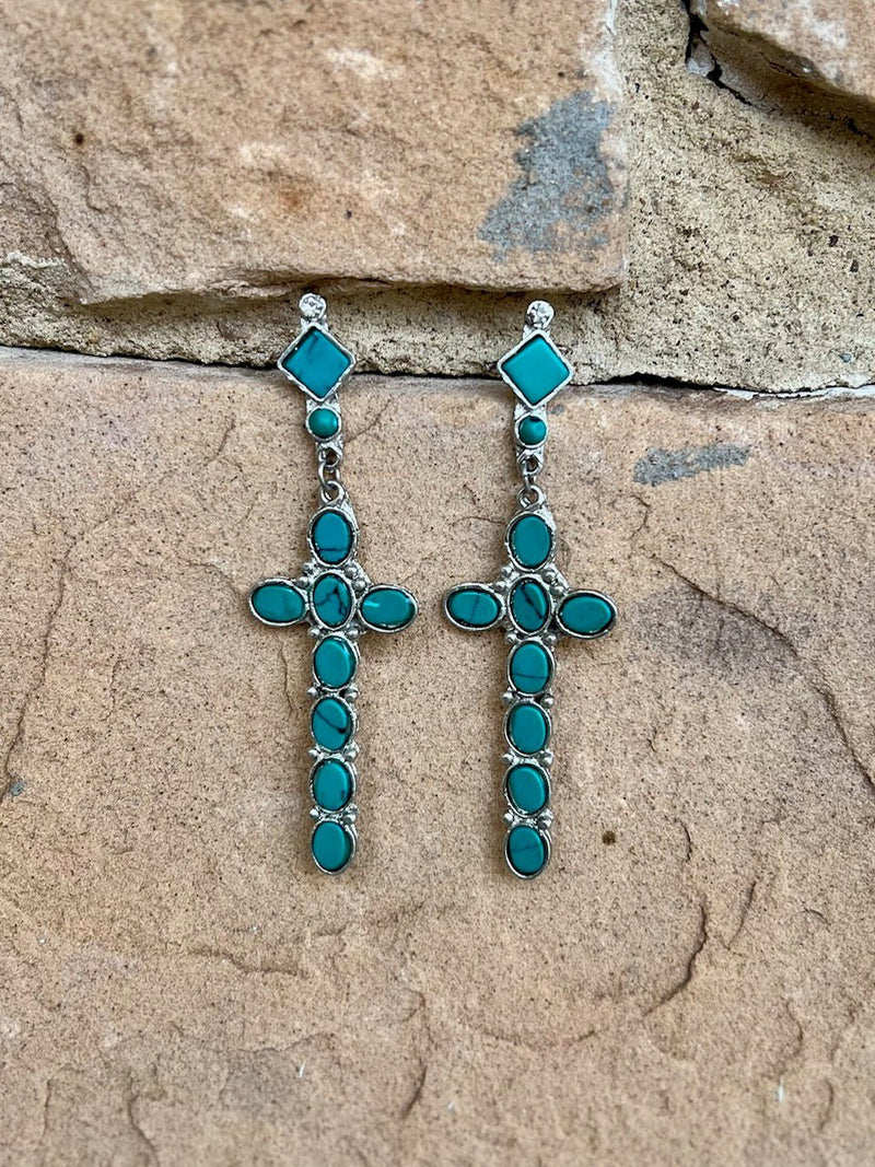 The OL' Faithful Earrings are a 3 1/2" silver dangle cross.  with multi turquoise clay stones inlayed,  attached to a 1" rhinestone and turquoise dangle with post back.  Cross is 1" W X 2 1/2" L.