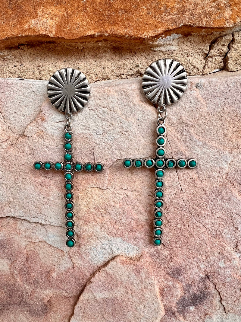 The Faith Over Fear Earrings are a 4" silver dangle cross with multi turquoise stones inlayed,  attached to a 1" round concho with post back.  Cross size is: 1 1/2" W X 2 3/4"L, attached to concho with dangle is 4" in total length. 