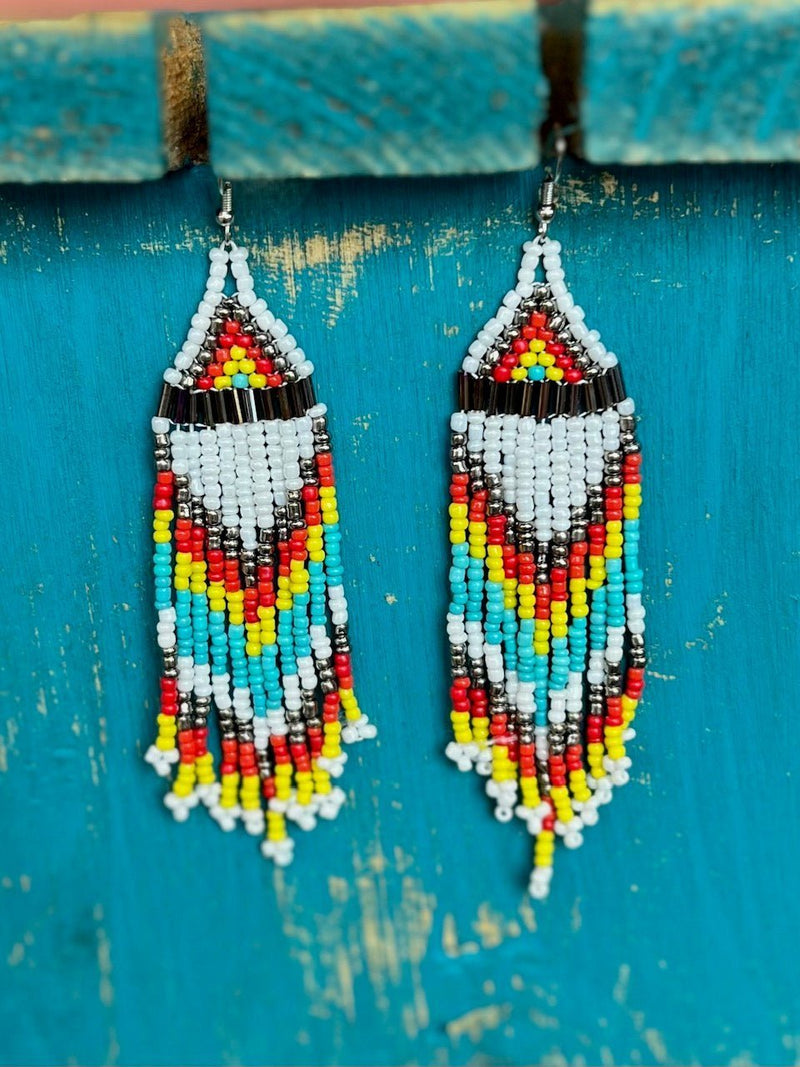 The Kiowa Seed Bead Earrings are a multi bead, multi strand, Aztec design dangle design. The colors really stand out and would add tons of color to any outfit. The total length of the earrings a 3 1/2".