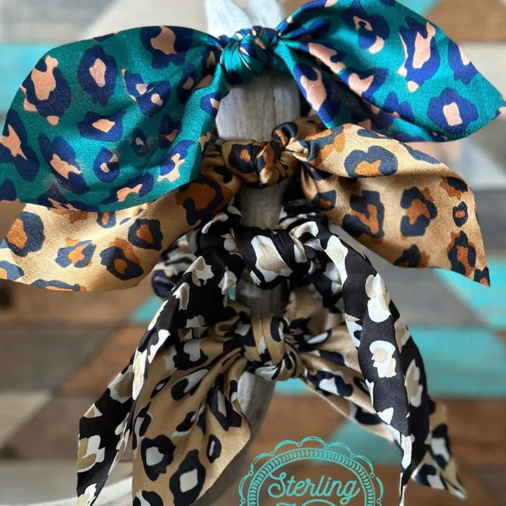 This scrunchie fits all hair types! There are 4 different color choices in this scrunchie,  you are sure to love these! They are the same silky material as our wild rags so there will be no damage to your hair! They have a 4" hanging tied bow on top that makes these scrunchies absolutely precious!!   INNER WIDTH: 1.5"