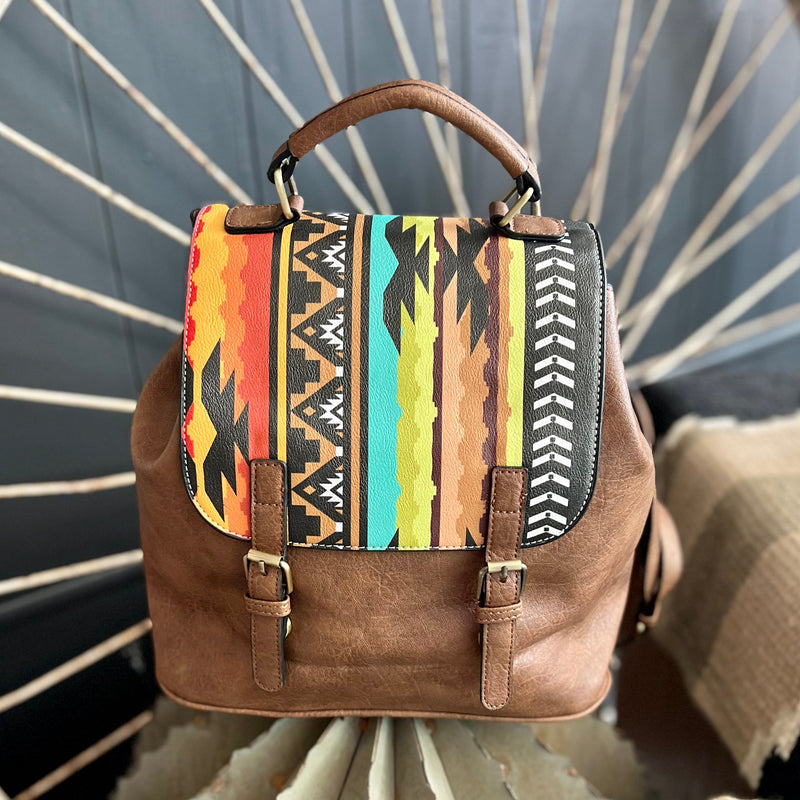 Durable and eye-catching, the Painted Warrior Expandable Backpack is crafted from high-quality leather with a unique Aztec pattern in bright, vibrant colors. The expandable design offers increased storage capacity and the shoulder straps make it easy to carry. Perfect for everyday or travel use.    14"W X 15" L