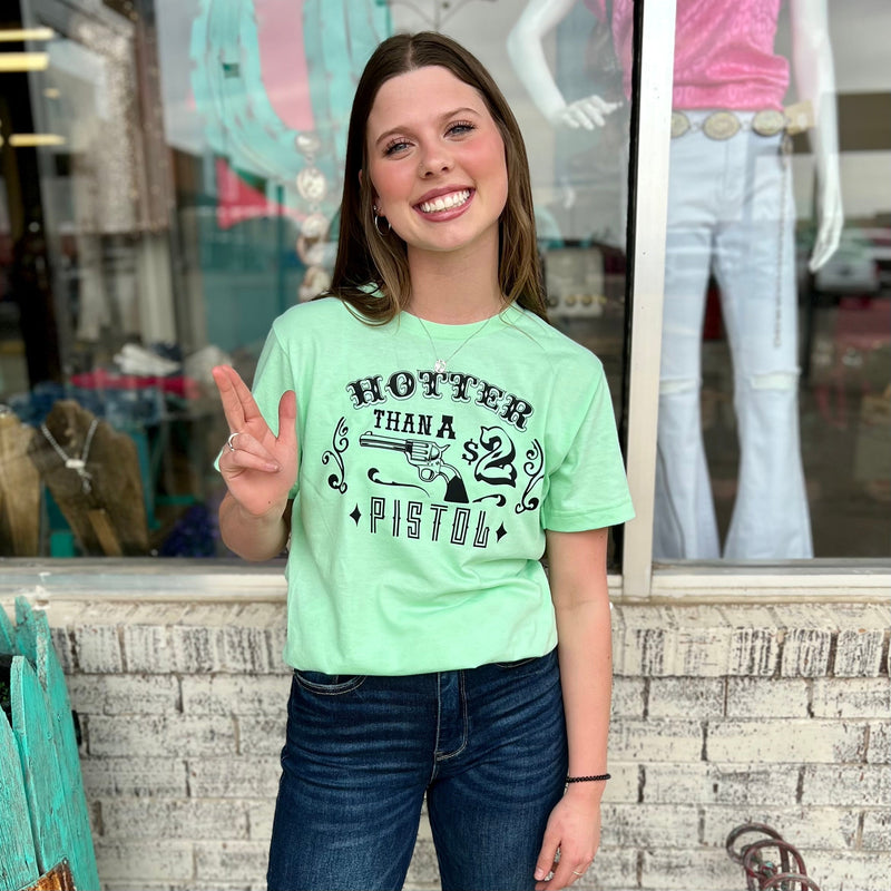 Our Hotter Than A $2 Pistol Tee is perfect for any occasion. Made from 50% Cotton & 50% Polyester, this loose fitting, short sleeve tee features a vibrant lime green base and black text. Perfect for everyday wear and guaranteed to make a statement.
