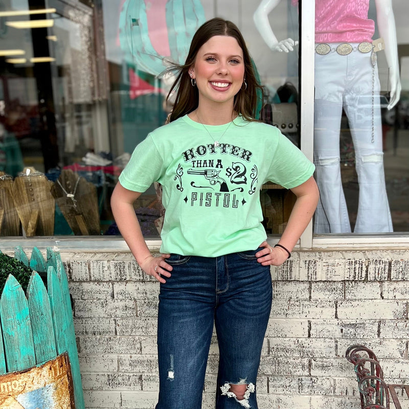 Our Hotter Than A $2 Pistol Tee is perfect for any occasion. Made from 50% Cotton & 50% Polyester, this loose fitting, short sleeve tee features a vibrant lime green base and black text. Perfect for everyday wear and guaranteed to make a statement.