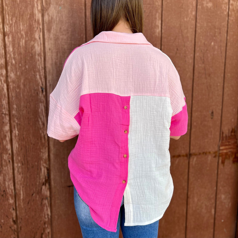 This stylish Blocked In Pink Blouse offers a modern take on the classic polo shirt. With a flattering v-neckline, crisp pink coloring, and a stylish front pocket, it's the perfect combination of comfort and sophistication. Short sleeves make it perfect for the office or a day out.  100% Cotton