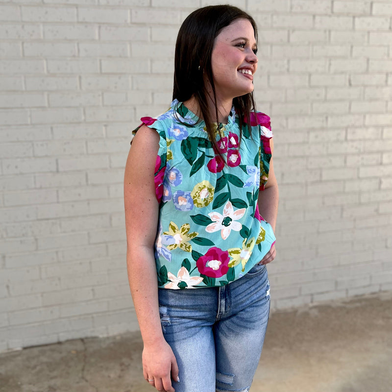 Our lightweight Floral Ruffle Tank is specifically crafted with a colorful floral print and trim of ruffles for an extra touch of style. Ideal for warm weather days, this timeless tank top is the perfect addition to any wardrobe.  100% Viscose