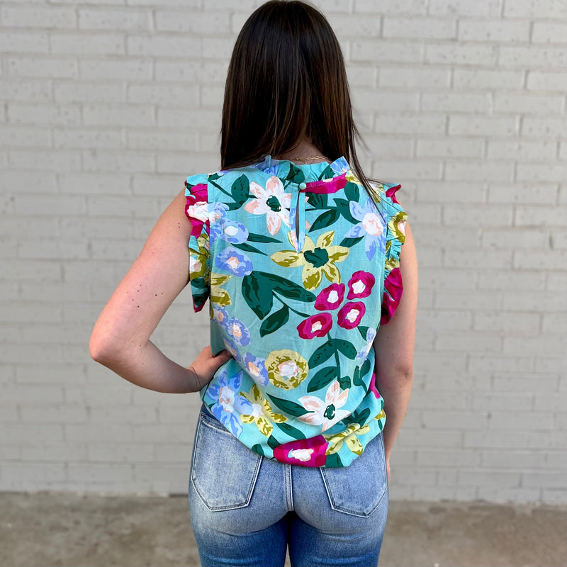 Our lightweight Floral Ruffle Tank is specifically crafted with a colorful floral print and trim of ruffles for an extra touch of style. Ideal for warm weather days, this timeless tank top is the perfect addition to any wardrobe.  100% Viscose