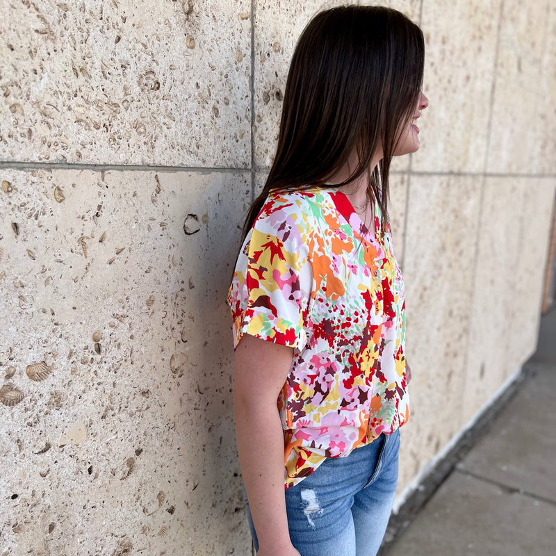 Bring joy to your wardrobe this season with the stylish Summer Garden Top! This white shirt features a multi-colored, boho-inspired floral print, along with a flattering v-neck and short sleeves. Perfect for spring and summer days!  100% Polyester